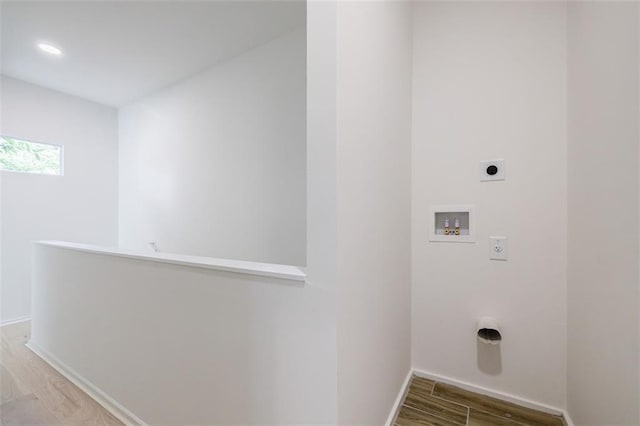 laundry room featuring baseboards, washer hookup, laundry area, wood finished floors, and electric dryer hookup