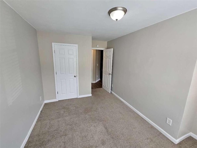 unfurnished bedroom featuring carpet and a closet