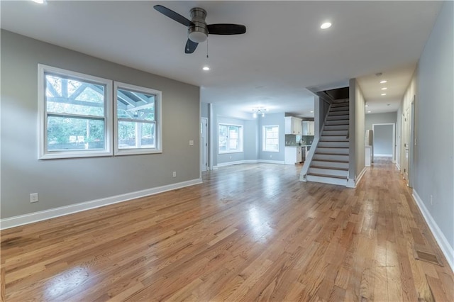 unfurnished living room with ceiling fan and light hardwood / wood-style floors