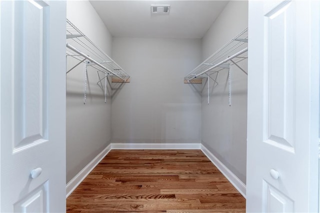 walk in closet featuring hardwood / wood-style flooring