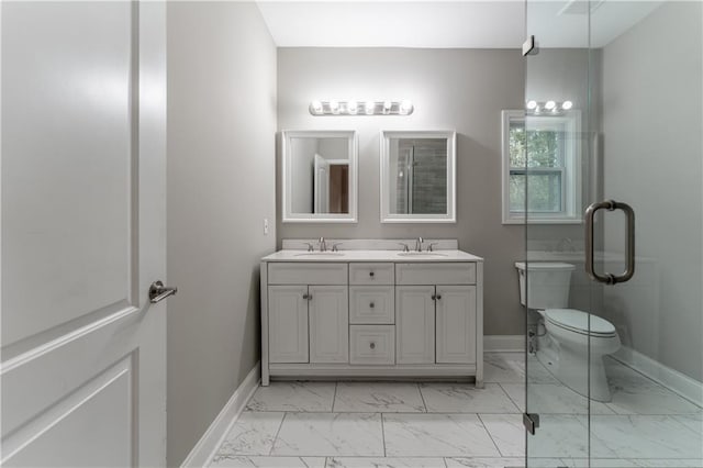 bathroom featuring double vanity, baseboards, and marble finish floor