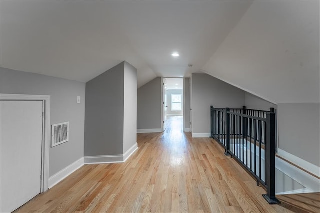 bonus room with lofted ceiling and light hardwood / wood-style flooring