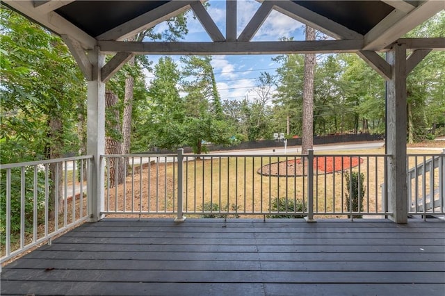 wooden terrace with a lawn