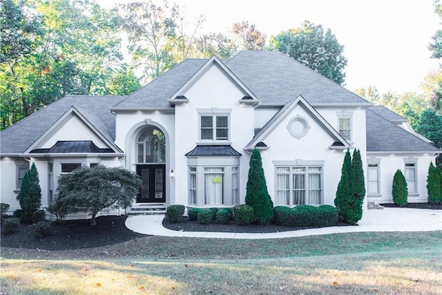 3258 Bransley Way, Duluth, GA 30097 - french country home featuring a standing seam roof, roof with shingles, and stucco siding