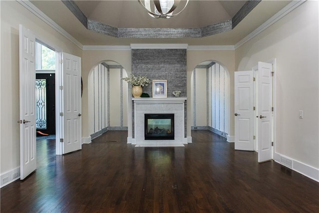 3258 Bransley Way, Duluth, GA 30097 - unfurnished living room with arched walkways, a raised ceiling, dark wood-style floors, crown molding, and a brick fireplace