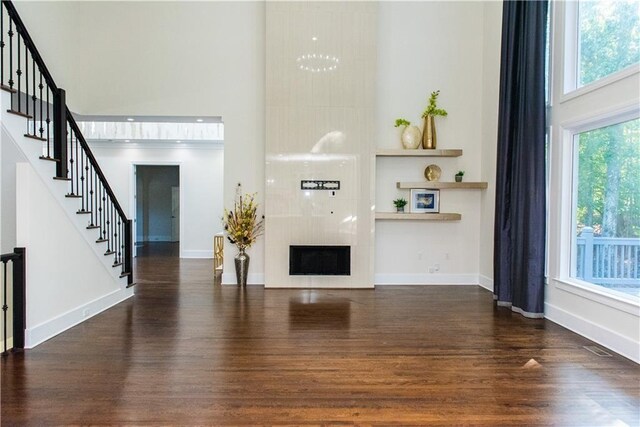 3258 Bransley Way, Duluth, GA 30097 - living area with a high ceiling, wood finished floors, stairway, and healthy amount of natural light