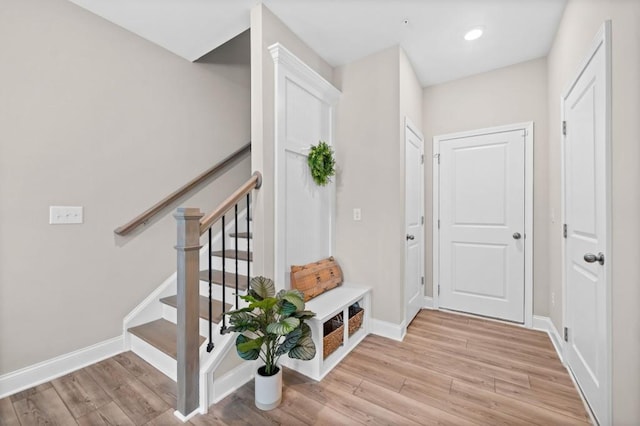 mudroom featuring baseboards, light wood-style floors, and recessed lighting
