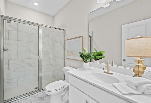 bathroom featuring marble finish floors, a shower stall, toilet, and vanity