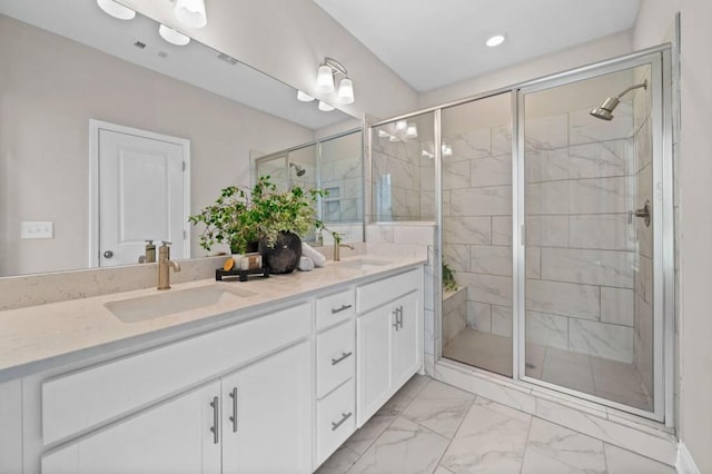 full bath featuring a shower stall, double vanity, marble look tiles, and recessed lighting