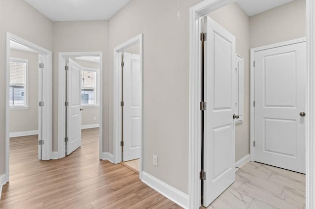 hallway featuring baseboards