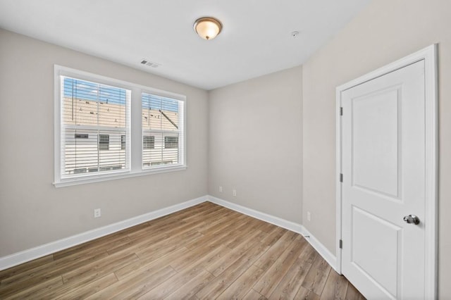 empty room with light wood-type flooring and baseboards