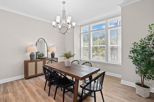 dining space featuring ornamental molding, baseboards, a chandelier, and light wood-type flooring