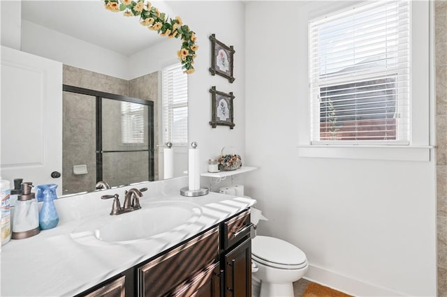 bathroom featuring vanity, toilet, and walk in shower