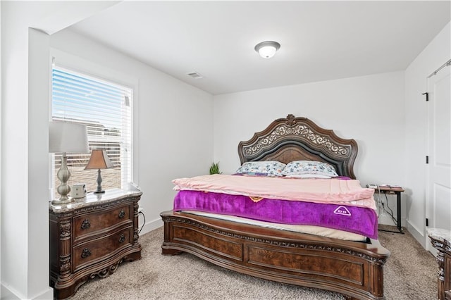 bedroom featuring light carpet