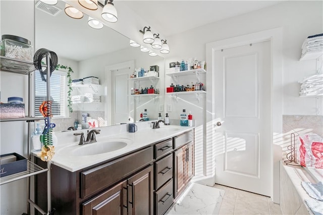 bathroom with a shower, vanity, and tile patterned floors