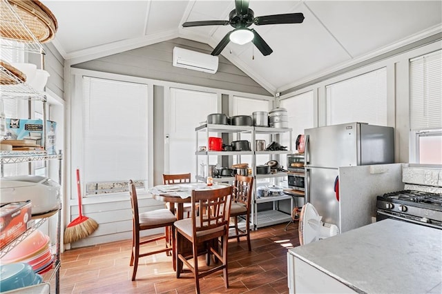 kitchen featuring a wall mounted air conditioner, stainless steel fridge, ceiling fan, crown molding, and lofted ceiling