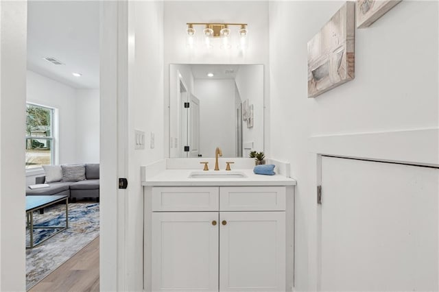 full bathroom with visible vents, wood finished floors, and vanity