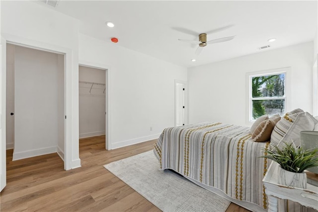 bedroom featuring light wood-style flooring, visible vents, baseboards, and recessed lighting