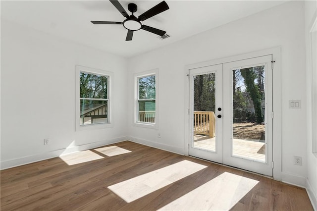 doorway to outside featuring baseboards, visible vents, a ceiling fan, wood finished floors, and french doors