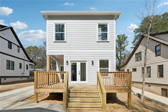 back of house featuring french doors and a wooden deck