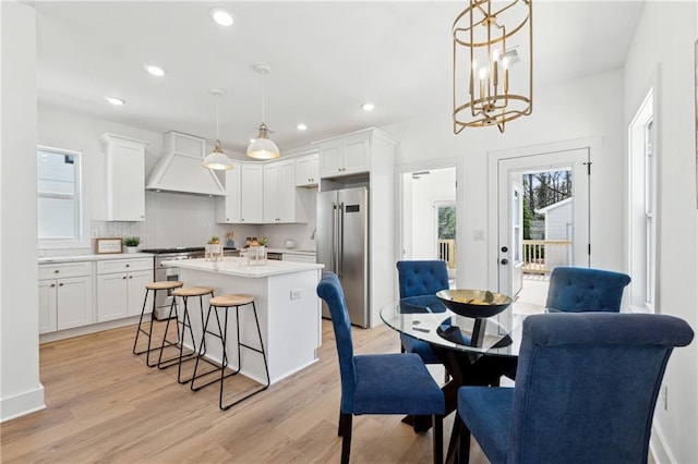 kitchen with premium range hood, high end appliances, and white cabinetry