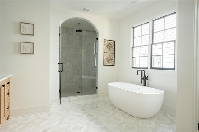 bathroom with vanity and separate shower and tub