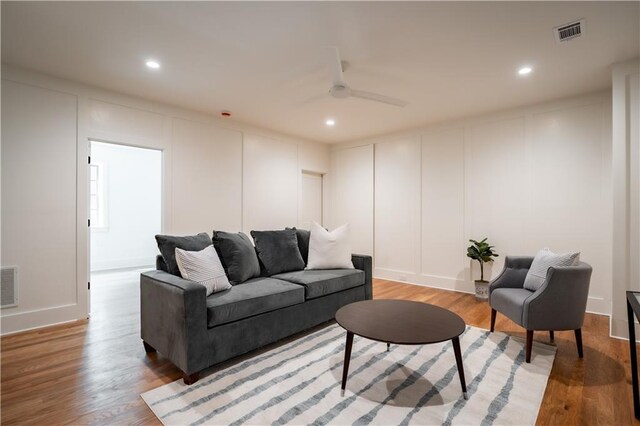 living room with ceiling fan and hardwood / wood-style flooring