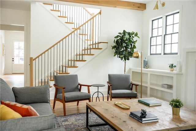 interior space with beam ceiling, hardwood / wood-style floors, and a healthy amount of sunlight