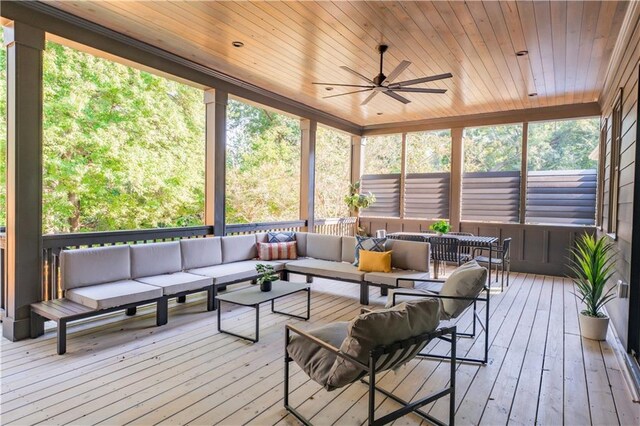 sunroom / solarium with ceiling fan, wood ceiling, and a healthy amount of sunlight