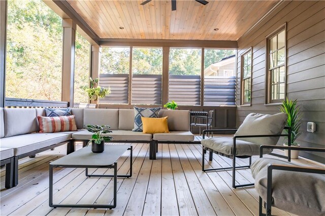 sunroom featuring wooden ceiling and ceiling fan