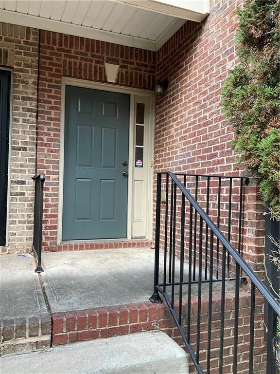 doorway to property with brick siding