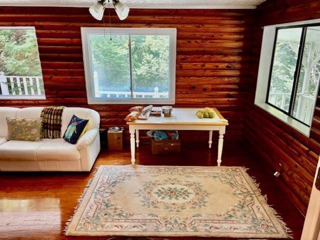 437 Apple Rdg Unit 2, Dawsonville, GA 30534 - sitting room with log walls, wood finished floors, and ceiling fan