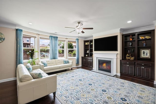 745 Newfield Ln, Alpharetta, GA 30004 - living area featuring crown molding, ceiling fan, a glass covered fireplace, dark wood-style flooring, and recessed lighting