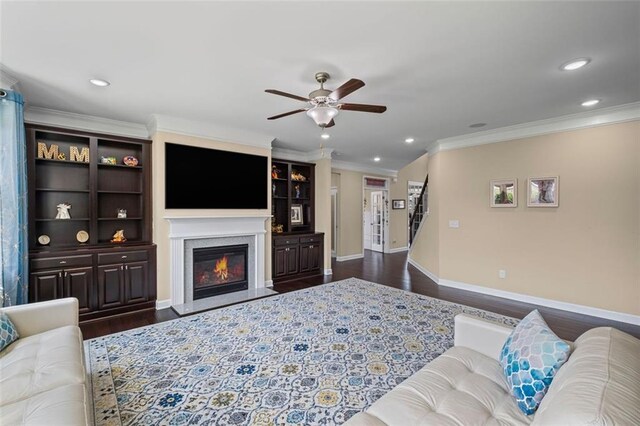 745 Newfield Ln, Alpharetta, GA 30004 - living area with dark wood-type flooring, ceiling fan, ornamental molding, a glass covered fireplace, and recessed lighting