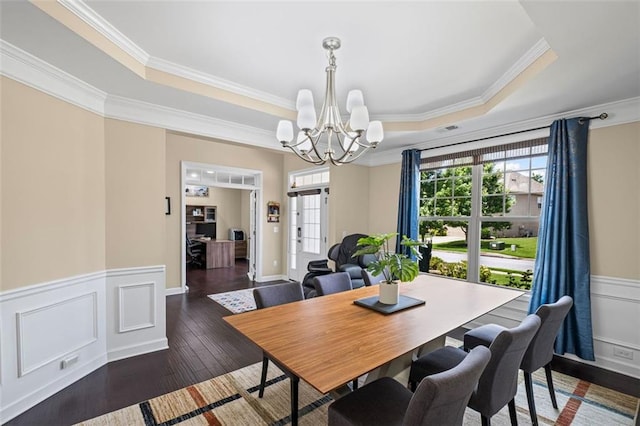 745 Newfield Ln, Alpharetta, GA 30004 - dining room with a raised ceiling, a chandelier, crown molding, a wainscoted wall, and wood-type flooring