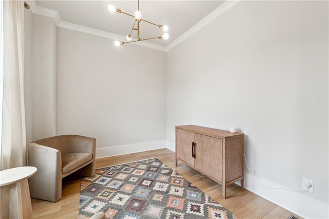 2565 Cork St, Braselton, GA 30517 - living area with crown molding, a chandelier, light wood finished floors, and baseboards