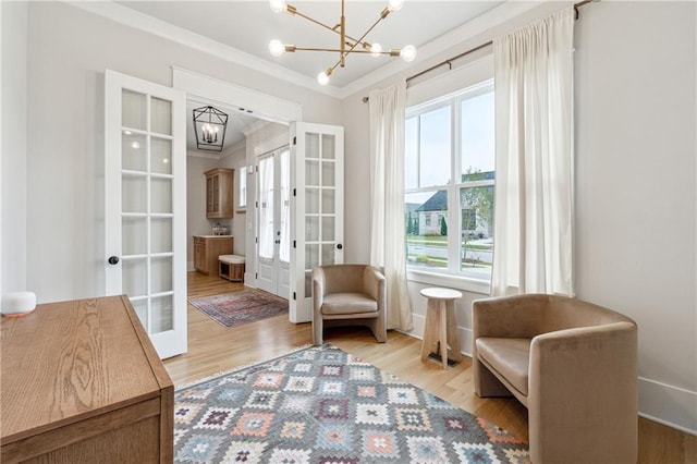 2565 Cork St, Braselton, GA 30517 - living area featuring french doors, a chandelier, wood finished floors, and ornamental molding