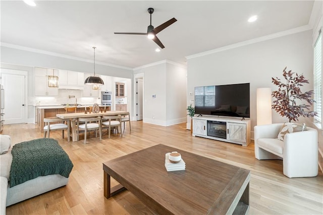 2565 Cork St, Braselton, GA 30517 - living room featuring ceiling fan, ornamental molding, light wood-type flooring, and recessed lighting