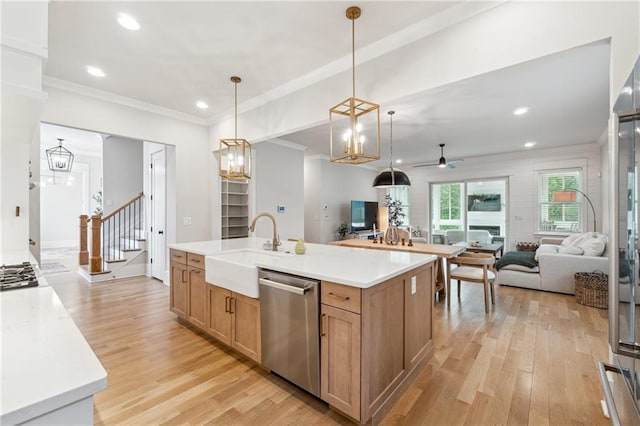 2565 Cork St, Braselton, GA 30517 - kitchen featuring appliances with stainless steel finishes, a sink, light wood-type flooring, ceiling fan, and crown molding