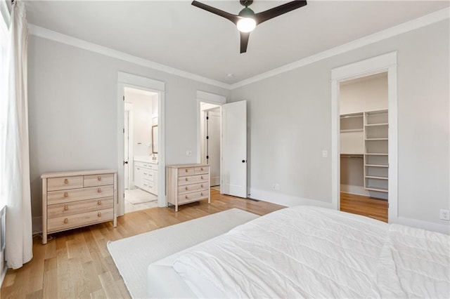 2565 Cork St, Braselton, GA 30517 - bedroom featuring crown molding, light wood-style flooring, a spacious closet, connected bathroom, and a ceiling fan
