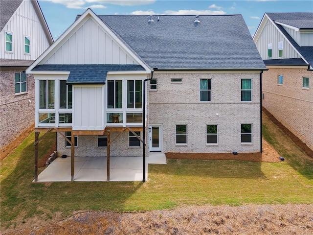 2565 Cork St, Braselton, GA 30517 - back of house featuring board and batten siding, a shingled roof, a patio, brick siding, and a sunroom