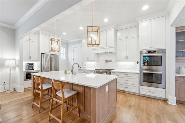 2565 Cork St, Braselton, GA 30517 - kitchen with appliances with stainless steel finishes, ornamental molding, tasteful backsplash, recessed lighting, and light wood-type flooring