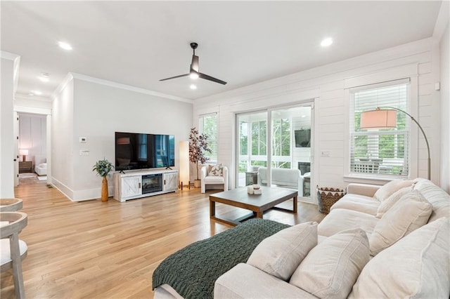 2565 Cork St, Braselton, GA 30517 - living area featuring a ceiling fan, plenty of natural light, ornamental molding, light wood finished floors, and baseboards