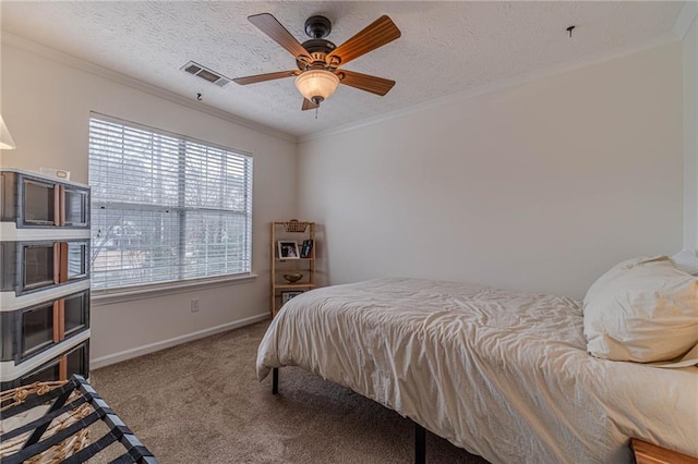 carpeted bedroom with crown molding, ceiling fan, and a textured ceiling