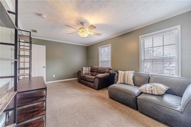 carpeted living room featuring ceiling fan, crown molding, and a textured ceiling