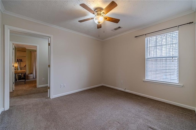 carpeted empty room with ceiling fan, ornamental molding, and a textured ceiling