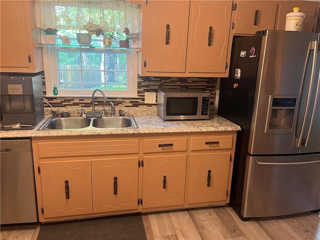 148 River N Blvd, Macon, GA 31211 - kitchen with light countertops, a sink, light wood-style floors, tasteful backsplash, and appliances with stainless steel finishes