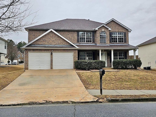 view of front of home featuring a front yard, a garage, and covered porch