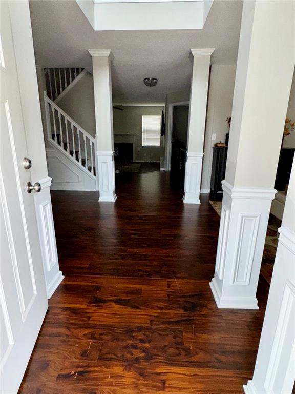 hallway with dark hardwood / wood-style flooring