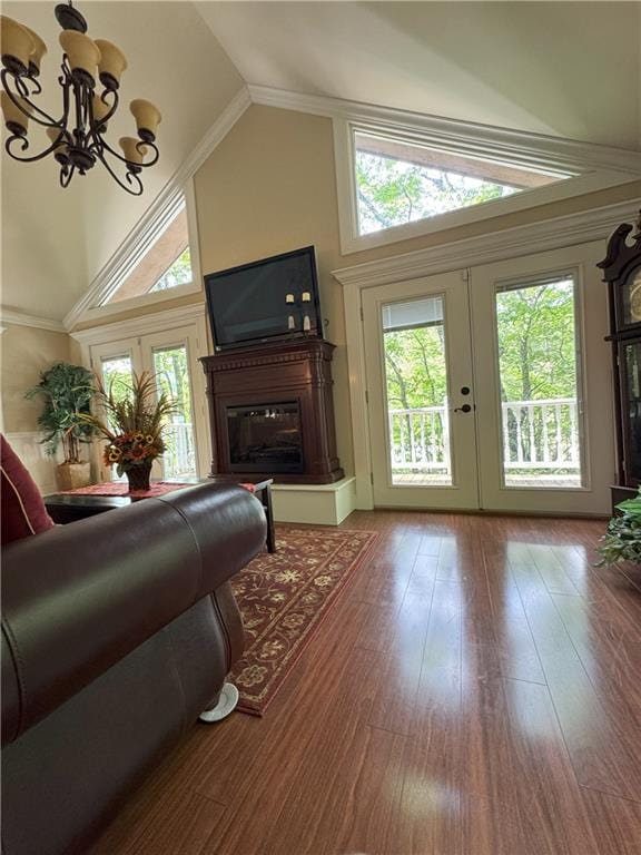 334 Eagle Cir, Dillard, GA 30537 - living room with french doors, healthy amount of natural light, a chandelier, high vaulted ceiling, and wood finished floors